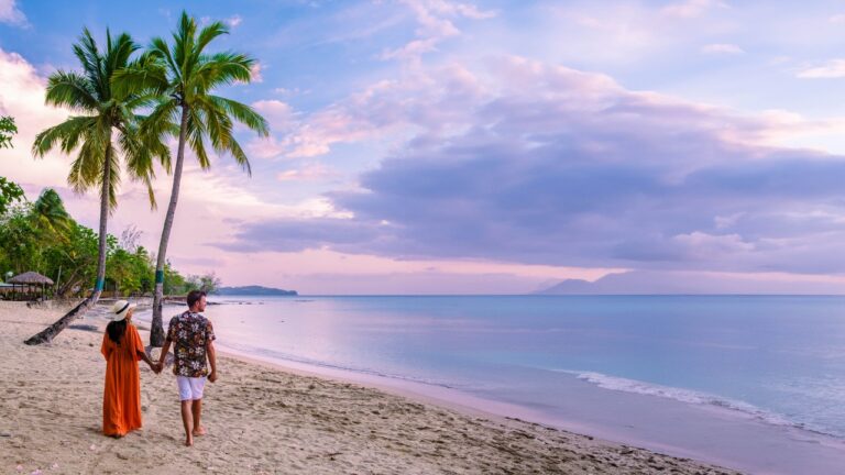 couple on beach with palm trees sunset at the tropical beach of saint lucia or st lucia caribbean