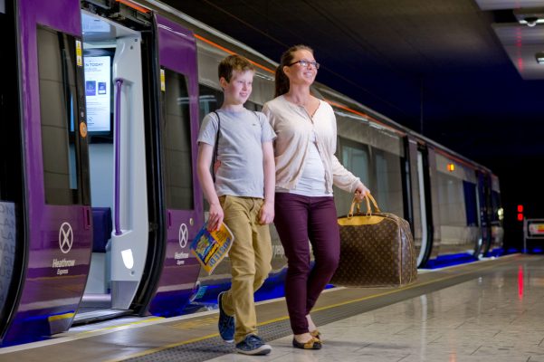 Two people getting off a Heathrow Express Train